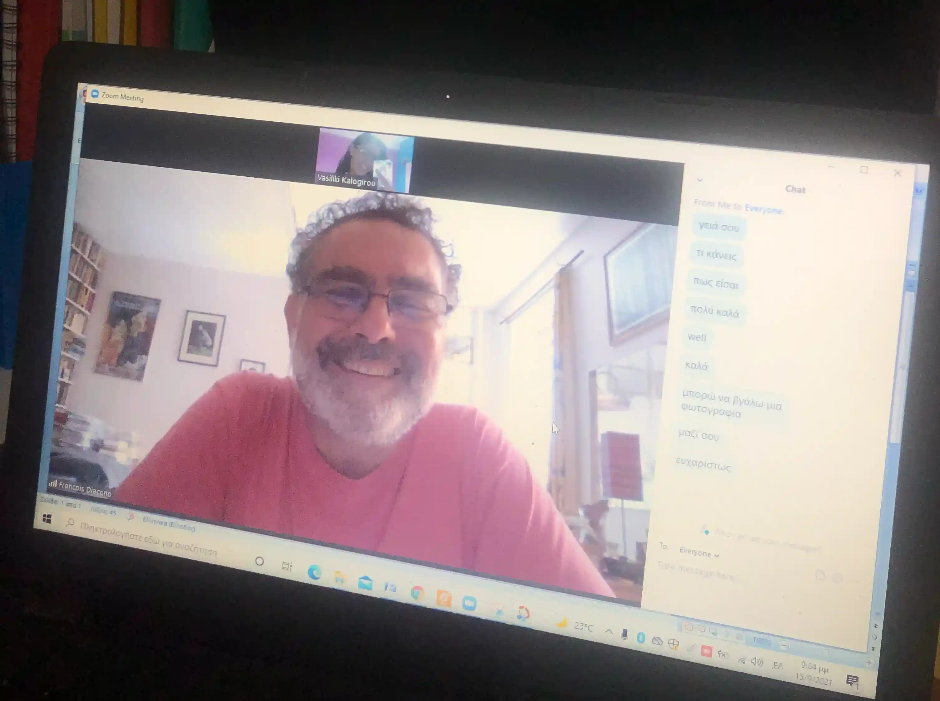 A smiling student on a Greek video lesson, chat full of Greek phrases