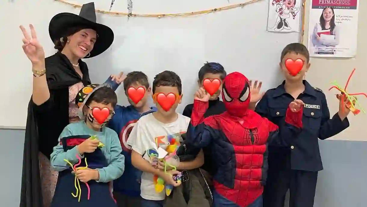 A junior Greek class in Halloween costumes — a witch teacher, Spider-Man, a police officer and more